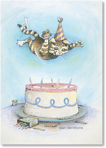 Cat jumping on birhtday cake