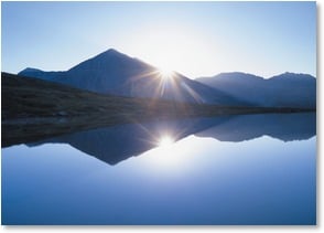 Sunset over mountains and lake