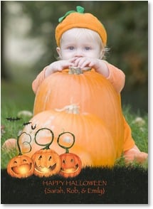 3 jack o lanterns with stems that spell out word "Boo" in front of moon