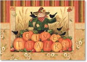 Scarecrow behind pumpkins Give Thanks