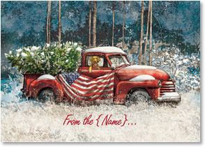Vintage red pickup truck with American flag and Christmas tree