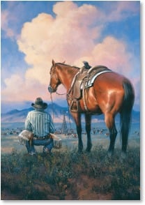 Cowboy next to horse watches cows