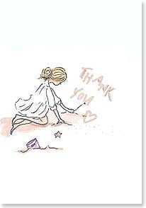 Girl on beach writing Thank you in the sand