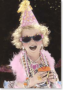 photo of a young blonde girl wearing a party hat and layers of colorful jewelry