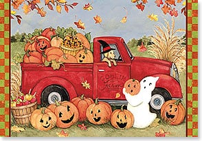 Dog in witch hat in red truck with pumpkins 