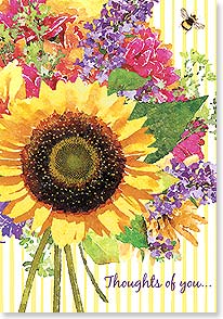 a large painted sunflower at the front of a colorful bouquet