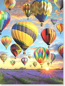 Many colorful hot air balloons at sunrise