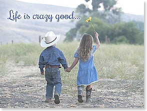 Little cowboy and girl hand in hand