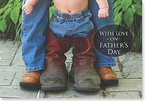 Baby between Dad's legs in jeans