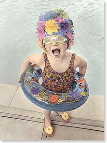 LITTLE GIRL IN SWIM CAP WITH FLOATIE