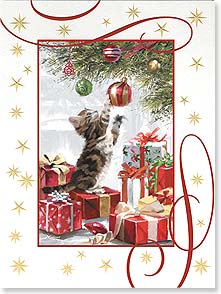 Kitten playing with ornament on Christmas tree