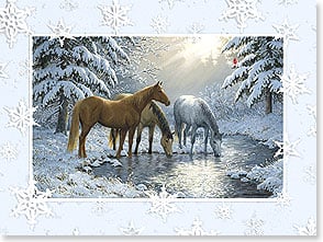 Three horses drinking from stream in snowy forest