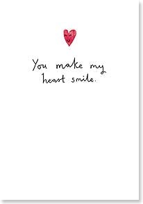 A small heart with a face drawn on it above a cursive scrawl saying you make my heart smile