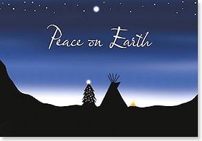 Silhouette of Christmas tree and tepee at dusk