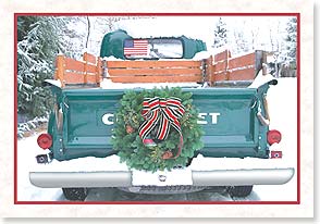 a classic pickup truck with a wreath on it in the snow