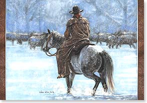 Cowboy on horseback tending to cattle in snow