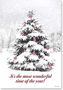 a christmas tree decorated with red ornaments in the middle of a very snowy forest
