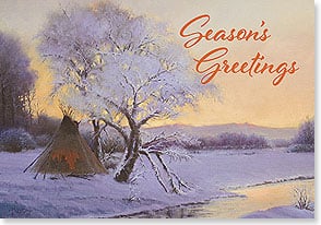 a teepee sitting under a frosty pair of trees near a stream at sunset