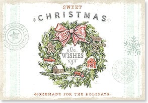 miniature houses and a gingerbread man sit nestled in a christmas wreath