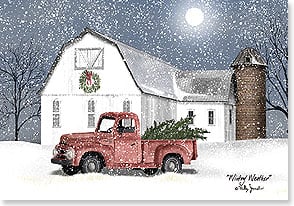 a red antique pickup truck sits outside a white barn during a snowfall at night