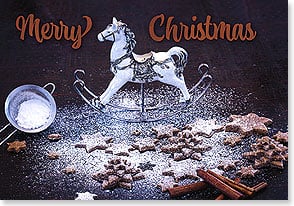 Toy rocking horse, cookies, cinnamon sticks sprinkled with powdered sugar