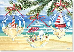 Glass ornaments hanging from palm tree on sunny beach 