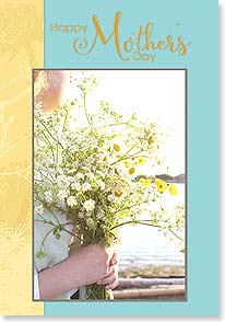 A photograph of hands holding a bouquet of small flowers
