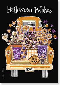 Old truck with baskets of flowers in bed and two cats staring out back window
