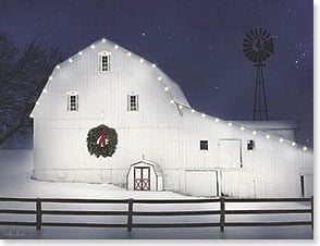 White barn decorated with lights in snow