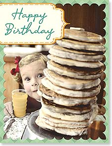 GIRL PEEKS OUT OF STACK OF PANCAKES